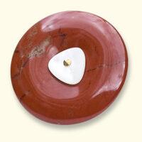 A jasper Mourning Button with a small button from a beloved one on it. The red jasper is often veined.