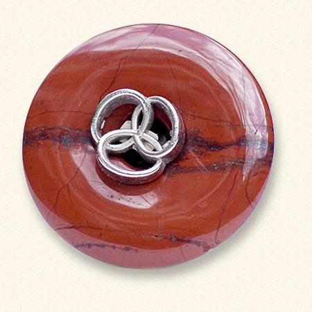 A jasper Mourning Button with a button of a beloved one on it. The red jasper is often veined.