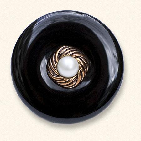 An onyx Mourning Button with a button of a loved one on it. The black onyx is always evenly coloured.